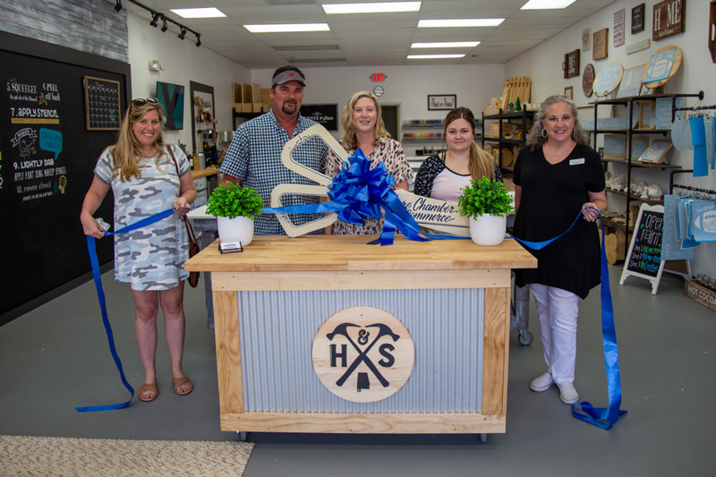 Hammer And Stain grand opening with a ribbon cutting