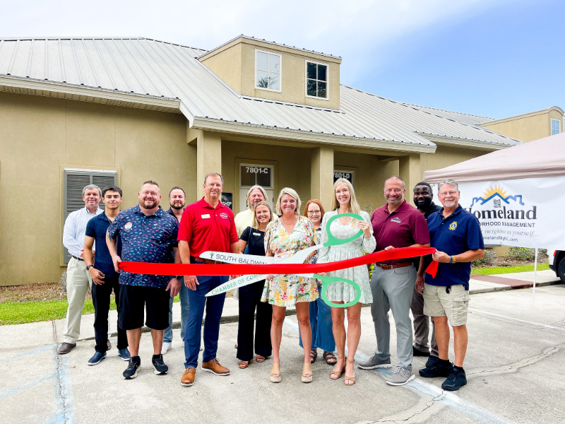 HOMELAND NEIGHBORHOOD MANAGEMENT CUTS RIBBON IN FOLEY